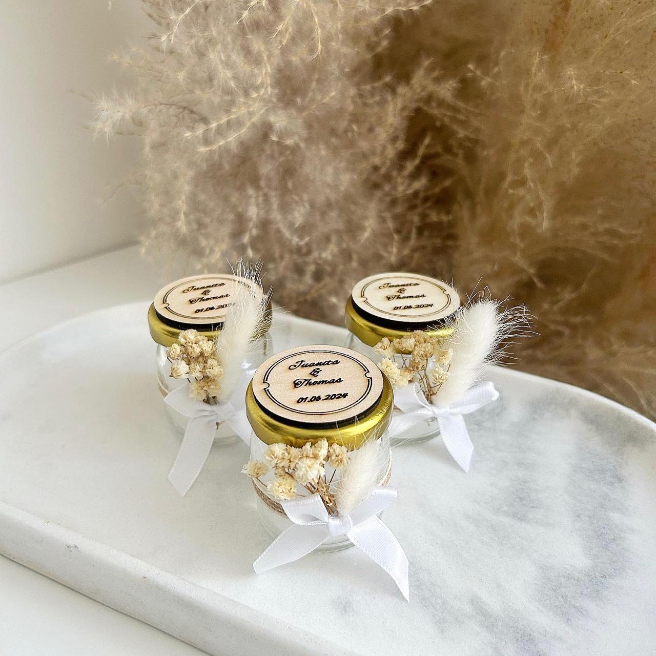 Bougie rustique personnalisée dans un petit pot en verre, couvercle doré, ruban blanc, fleurs séchées et plume, cadeau invité mariage.